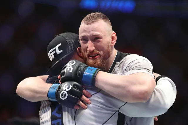 joe pyfer emotionally hugging a ufc fighter in the octagon