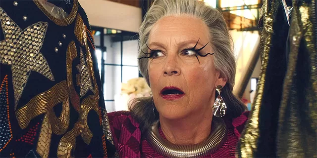 amie Lee Curtis in Freakier Friday, wearing a vibrant pink outfit and bold makeup with dramatic eyeliner, standing in a stylish boutique surrounded by colorful clothing and accessories, capturing a humorous body-swap comedy scene