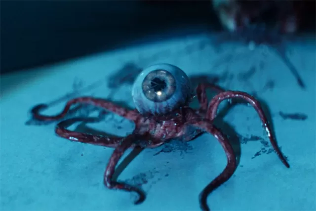tentacled eye monster from alien earth sitting on a table