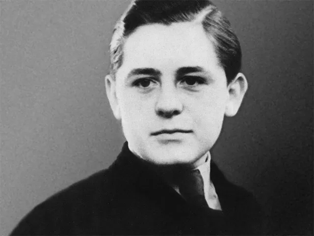 Vintage black-and-white portrait of Helmuth Hübener, the courageous teenage German resistance fighter against the Nazis, in a formal suit and tie, featured in a review of Angel Studios' upcoming WWII film Truth & Treason (2025).