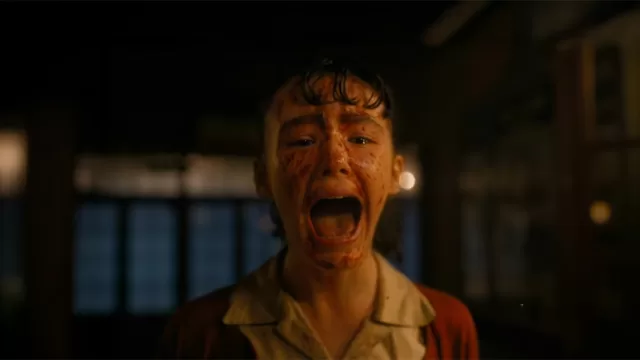 Clara Stack as Lilly Bainbridge screaming in blood-soaked horror scene from It: Welcome to Derry HBO Max series, Stephen King It prequel episode 1 cliffhanger, young actress with wet hair and terrified expression in dimly lit room.