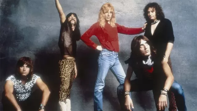 Cast of This Is Spinal Tap in character: Christopher Guest, Michael McKean as David St. Hubbins, Harry Shearer, Rob Reiner as Marty DiBergi director, and band members in iconic 1984 mockumentary rock band pose