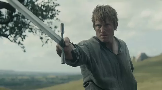 A Knight of the Seven Kingdoms (2026) banner – Peter Claffey as Ser Duncan the Tall wielding sword in intense pose under cloudy sky | HBO Dunk and Egg series premiered January 18, 2026 | Worth It or Woke review at https://worthitorwoke.com/