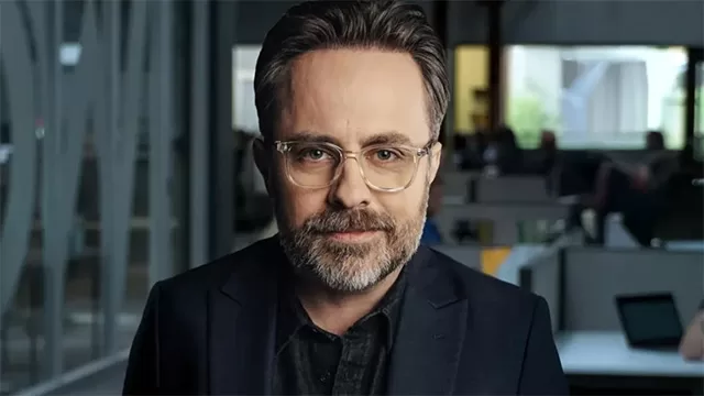 eremy Boreing Pendragon Cycle Rise of Merlin 2026: bearded director in navy suit glasses serious pose modern office – Daily Wire Arthurian fantasy film – anti-woke biblical values, woke Hollywood comparison, content warnings, and Christian family suitability rating on WorthItOrWoke.com"