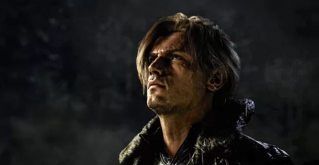 Resident Evil Requiem (2026) banner – Leon S. Kennedy close-up with blood-streaked face and intense upward gaze in dark rain | Capcom survival horror released February 27, 2026 | Worth It or Woke review at https://worthitorwoke.com/