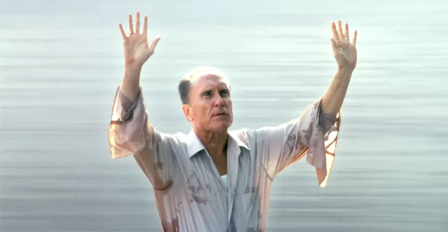 Robert Duvall in The Apostle (1997) – arms raised in iconic preaching scene by the water; tribute to the late Oscar-winning actor who passed away February 15, 2026 at age 95