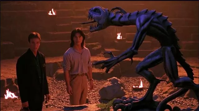 "Mortal Kombat 1995 movie Reptile creature close-up scary blue monster vs actors Johnny Cage scene classic video game adaptation arena torches – anti-woke review WOKE-O-METER rating & conservative Christian family-friendly verdict exposing woke Hollywood agenda on WorthItOrWoke.com