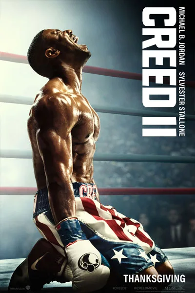 Creed II poster: Michael B. Jordan kneeling American flag shorts intense upward gaze muscular victory moment classic 2018 boxing legacy sequel Sylvester Stallone – conservative alternative to Rotten Tomatoes anti-woke WOKE-O-METER rating & Christian family-friendly verdict exposing woke Hollywood agenda on WorthItOrWoke.com