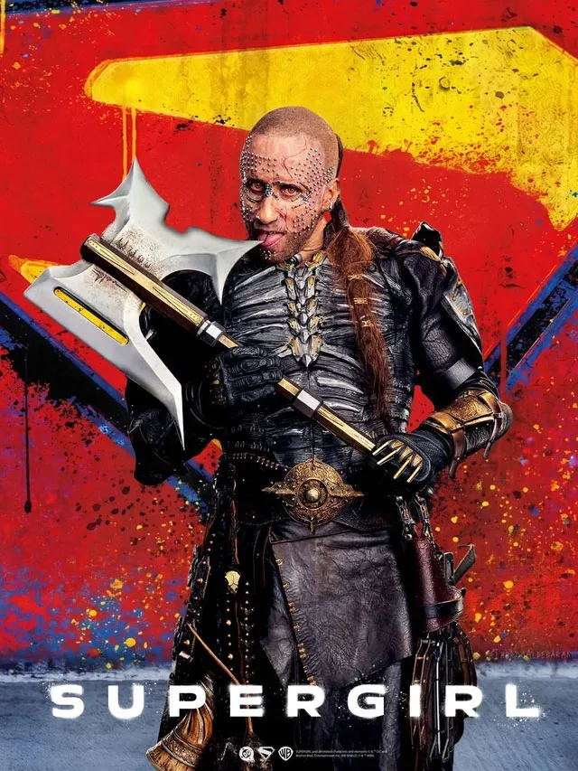 Supergirl 2026 movie villain Krem poster: bald warrior with facial markings and battle axe in dramatic armor pose against red and yellow background – conservative alternative to Rotten Tomatoes anti-woke WOKE-O-METER rating & Christian family-friendly verdict exposing woke Hollywood agenda on WorthItOrWoke.com