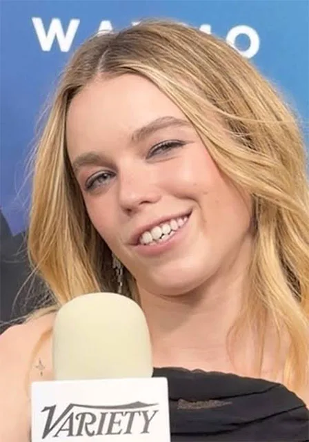 Milly Alcock Supergirl 2026 actress smiling press headshot with Variety microphone blonde hair interview photo – conservative alternative to Rotten Tomatoes anti-woke WOKE-O-METER rating & Christian family-friendly verdict exposing woke Hollywood agenda on WorthItOrWoke.com